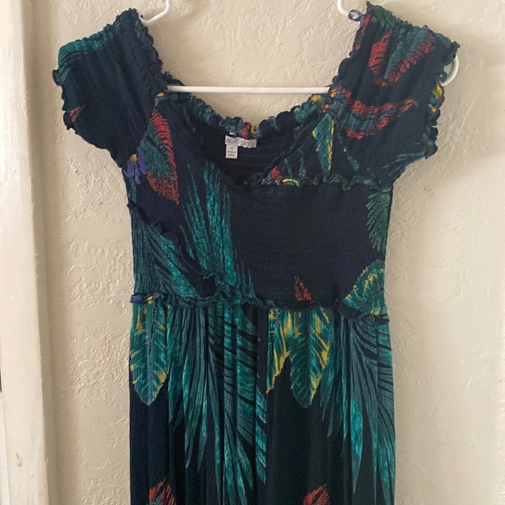 Women’s over the shoulder green pattern jumpsuit.